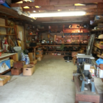 full garage with woodworking tools